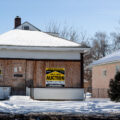 A home with lender foreclosure signage on it.