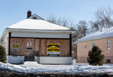 A home with lender foreclosure signage on it.