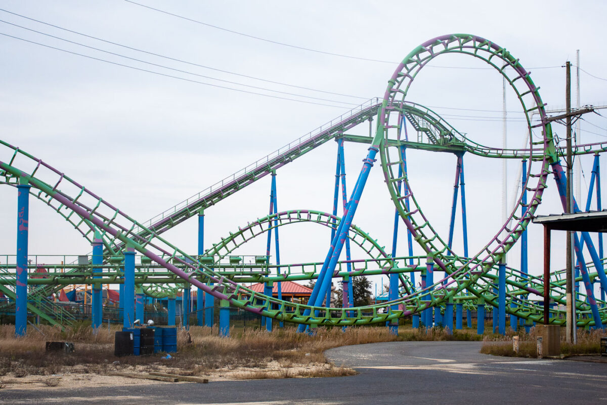 Abandoned green and purple roller coaster at Six Flags New Orleans, closed since Hurricane Katrina in 2005.