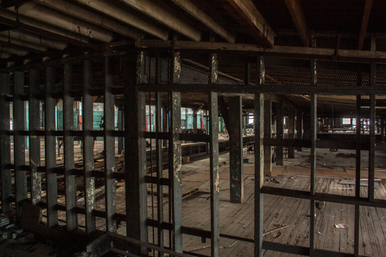 Interior of Abandoned Dixie Brewery, New Orleans 4 Interior of the abandoned Dixie Brewery in New Orleans, showing decaying wooden floors, support beams, and metal grating.
