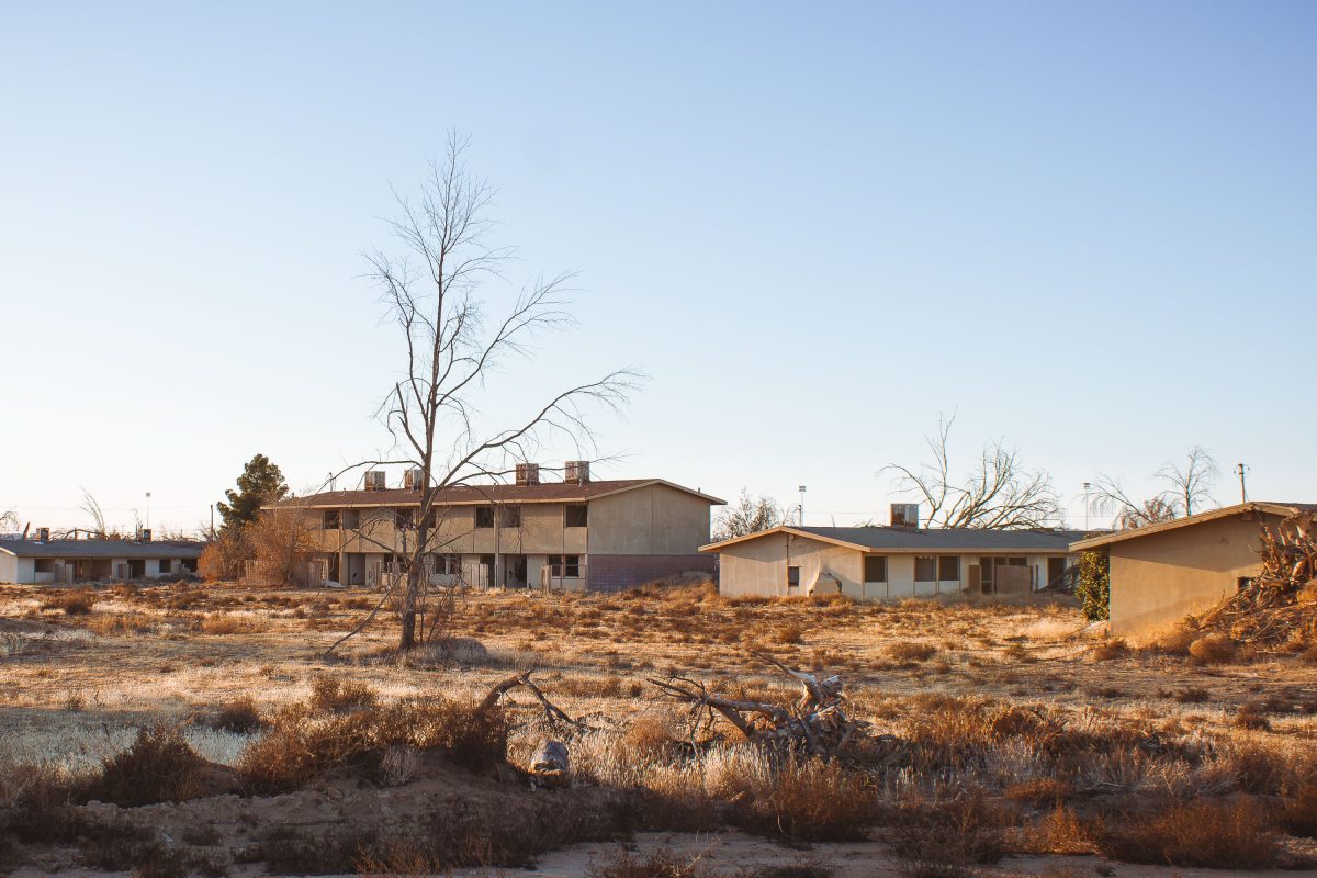 Abandoned residential structures and bare tree at George Air Force Base in Victorville, California.