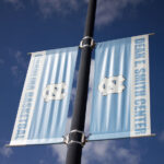Banners at the University of Carolina that read Dean E Smith Center Carolina Basketball.