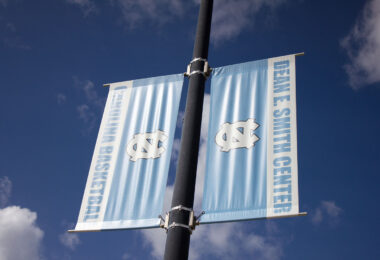 Banners at the University of Carolina that read Dean E Smith Center Carolina Basketball.