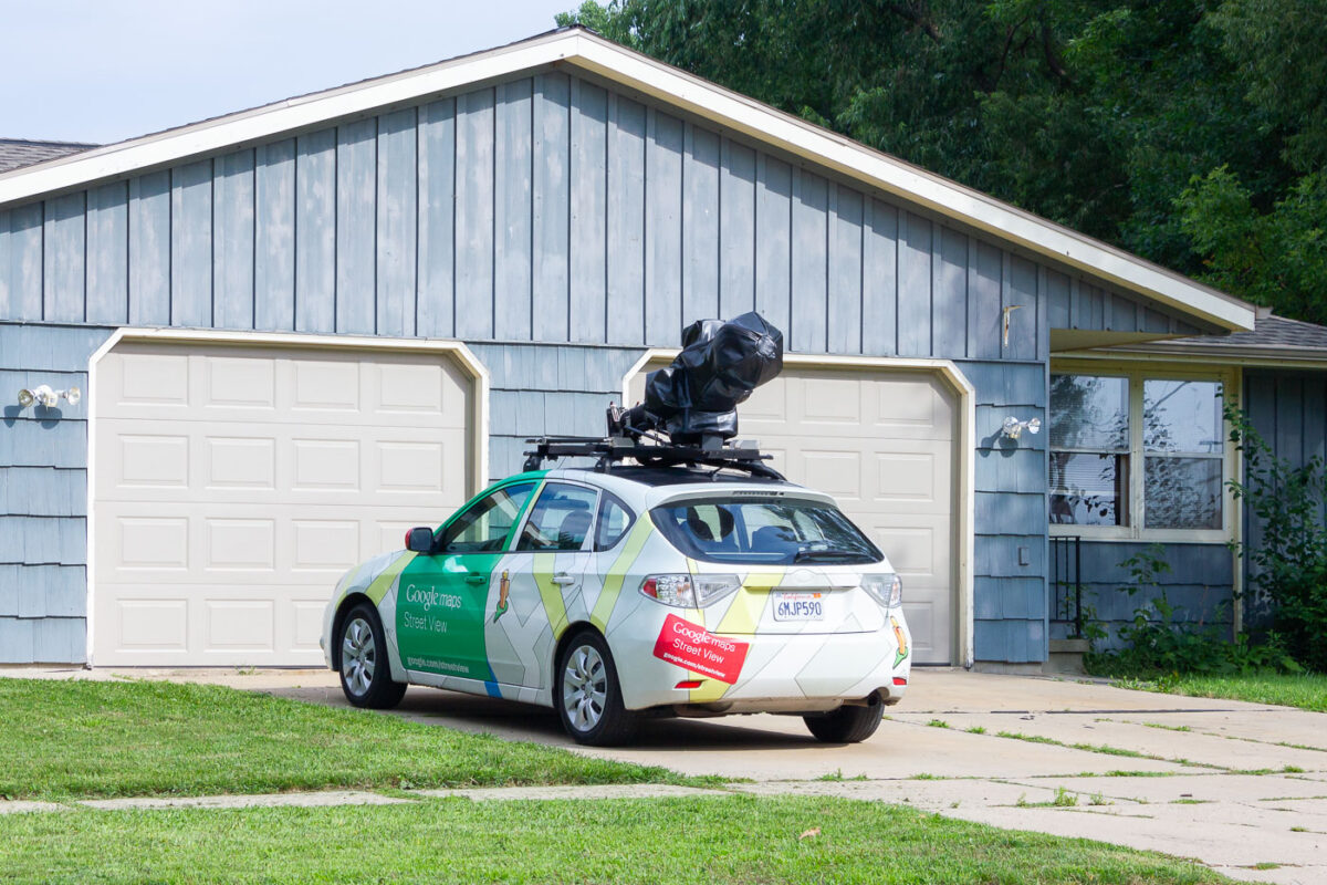 A Google Maps Street View car parked in a residential driveway.