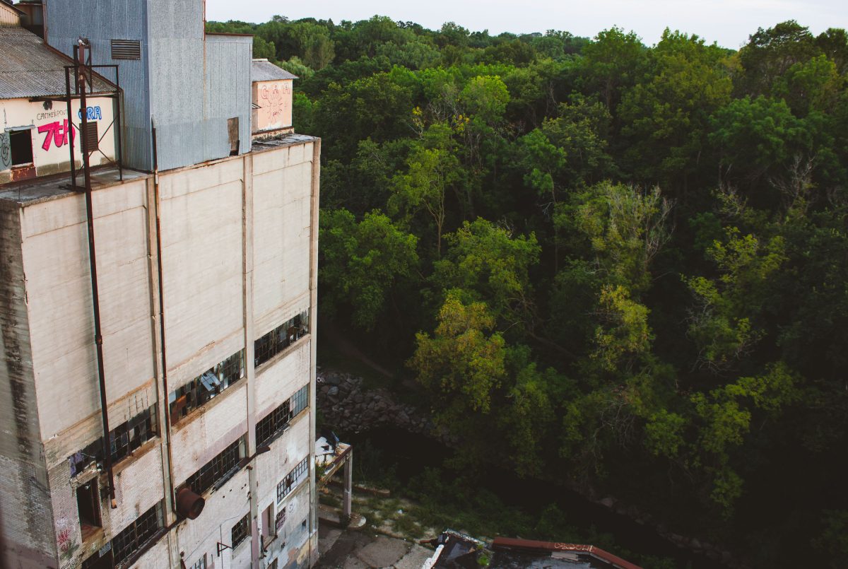 Abandoned Fruen Mill grain processing facility in Minneapolis overlooks forested Bassett Creek valley.