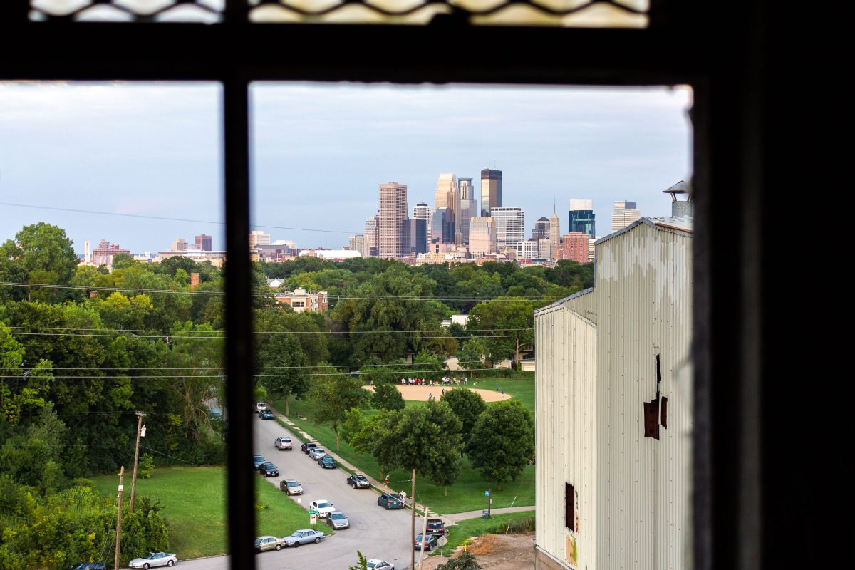 Minneapolis skyline viewed through a window from inside the abandoned Fruen Mill industrial building.