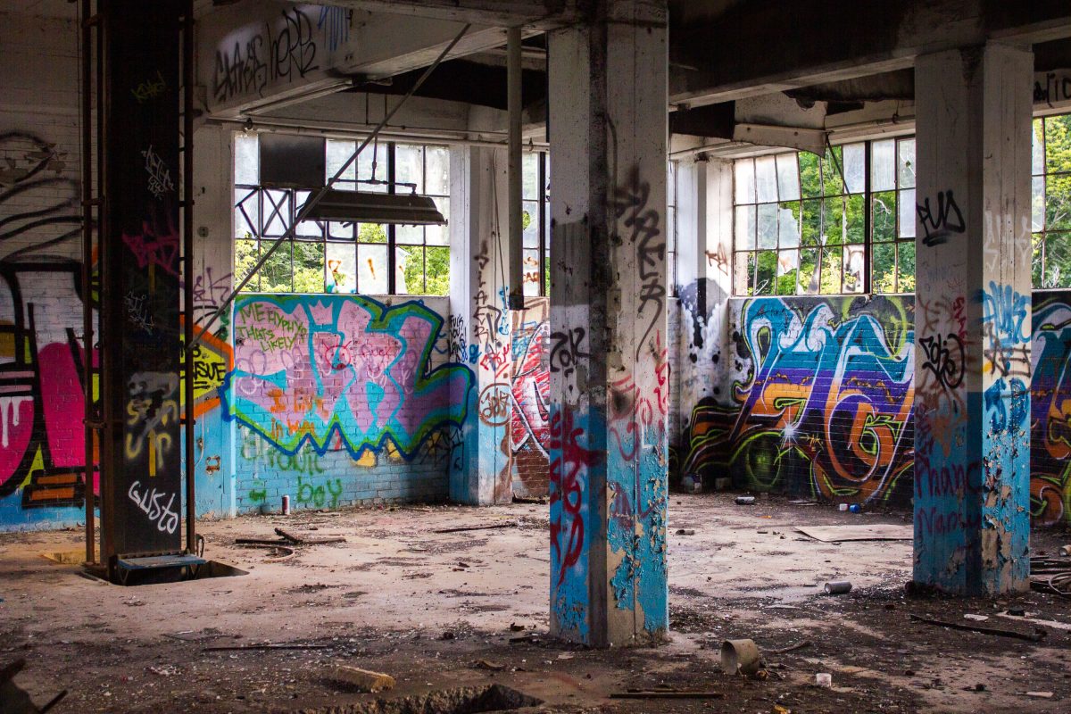 Abandoned Fruen Mill grain processing facility in Minneapolis with colorful graffiti on concrete pillars and deteriorating