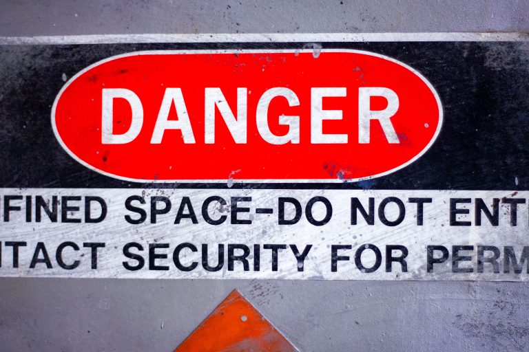 Confined Space Danger Sign with Entry Restriction 1 Danger sign for a confined space, indicating restricted entry and the need to contact security for permission. Found in industrial settings.
