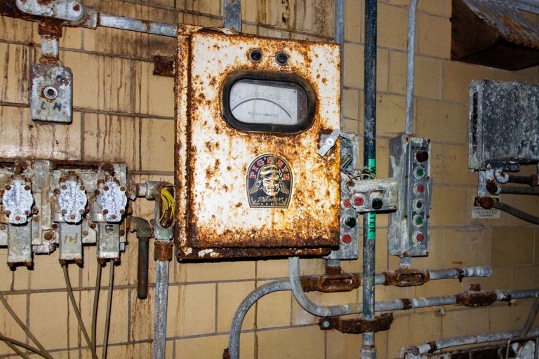 Rusted Control Panel, Schmidt Brewery, St. Paul 2 Heavily rusted electrical meter and vintage industrial switches mounted on a brick wall at Schmidt's Brewery in St. Paul.