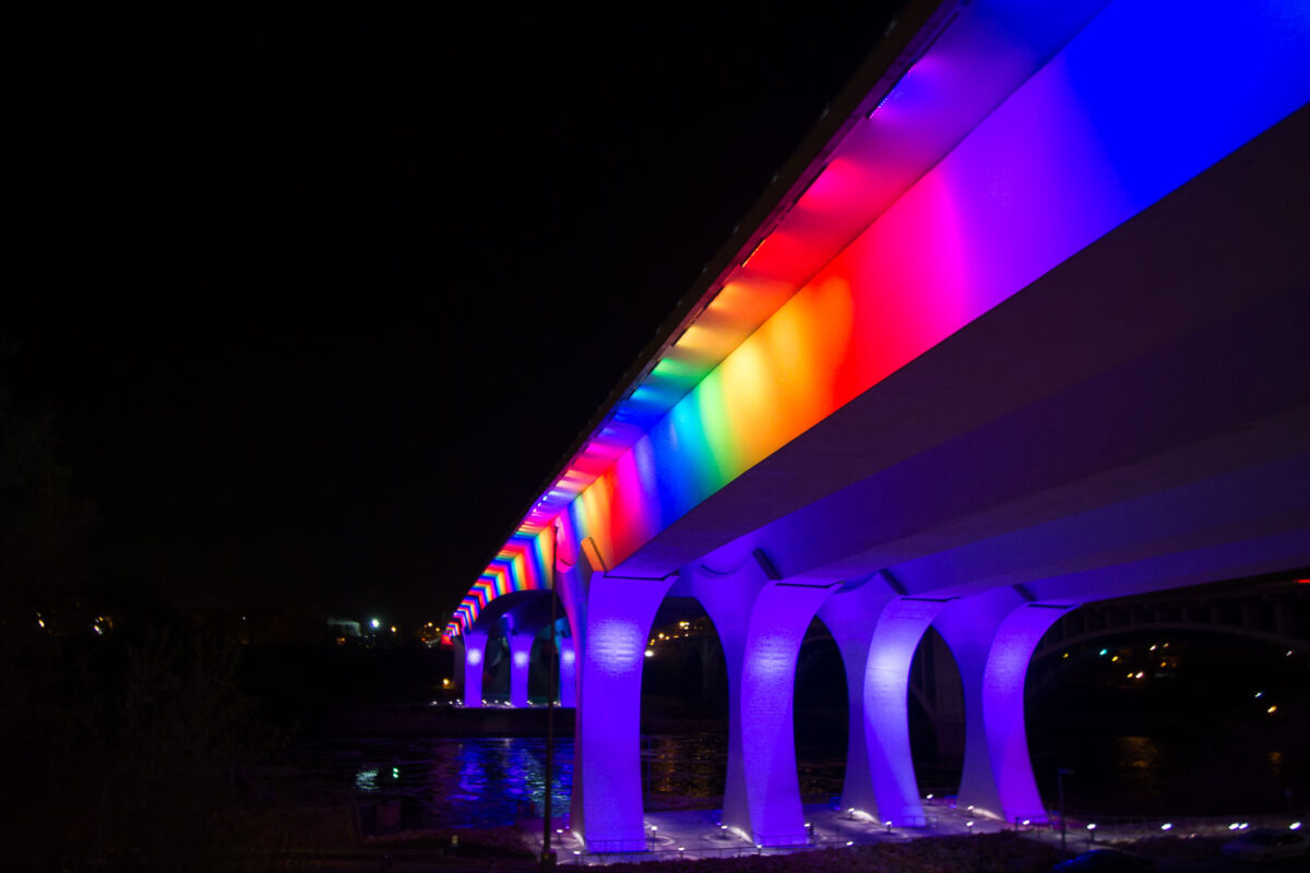 I-35W Bridge lit with rainbow colors.