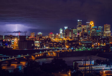 Downtown Minneapolis as seen from across the Mississippi River in 2013. The former Minnesota Vikings Stadium, the Metrodome, on the left side of the frame. The stadium has since been replaced by US Bank Stadium.