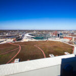 The green roof of the Target Center in Downtown Minneapolis with Target Field in the background.