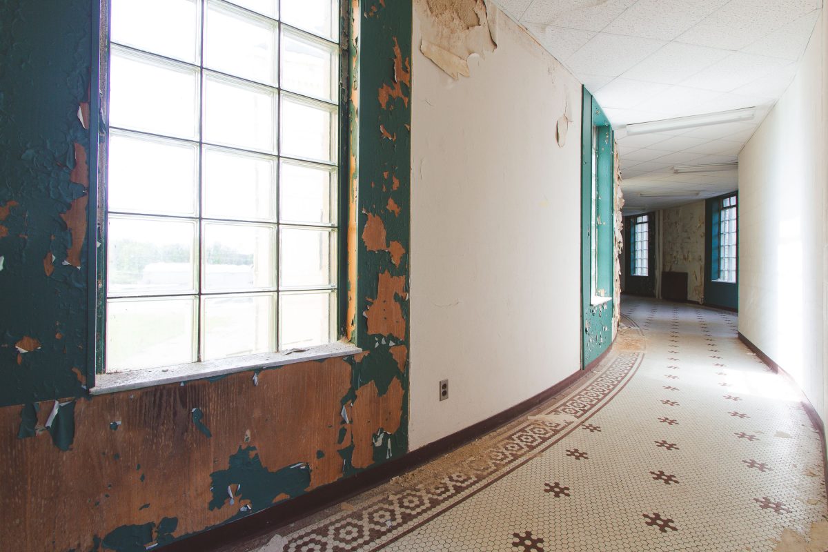 Curved corridor with peeling paint, Fergus Falls Kirkbride Building