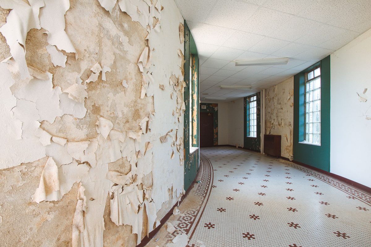 Curved corridor with peeling wallpaper, Fergus Falls Kirkbride Building