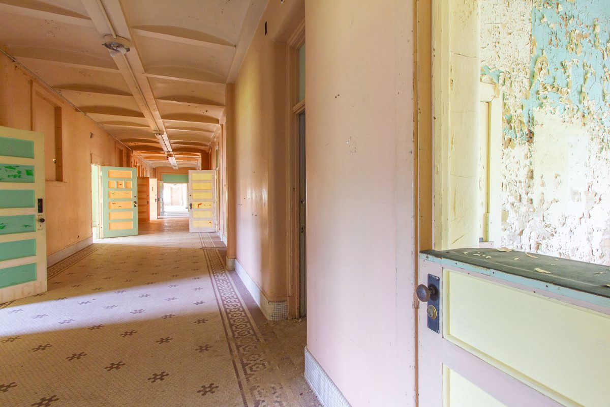 Curved ward hallway with mosaic tile floor, Fergus Falls Kirkbride Building