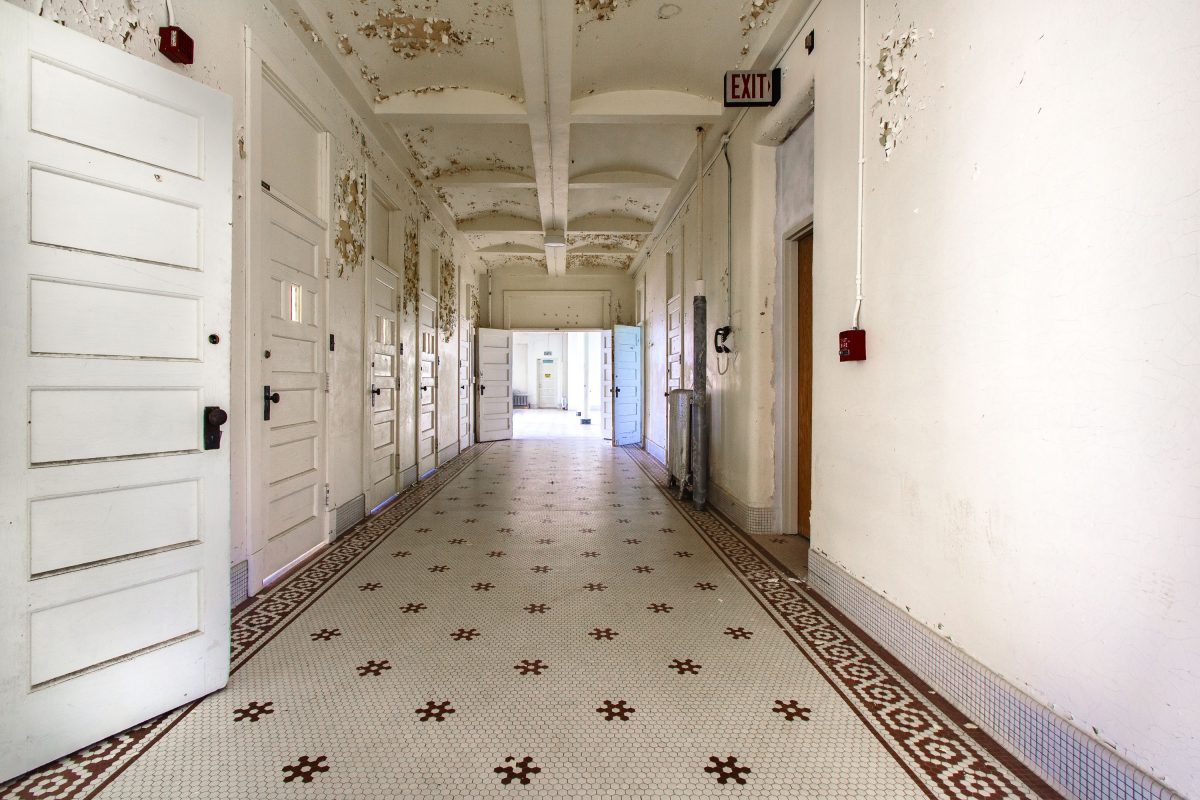Hexagonal-tile corridor with peeling ceiling, Fergus Falls Kirkbride Building