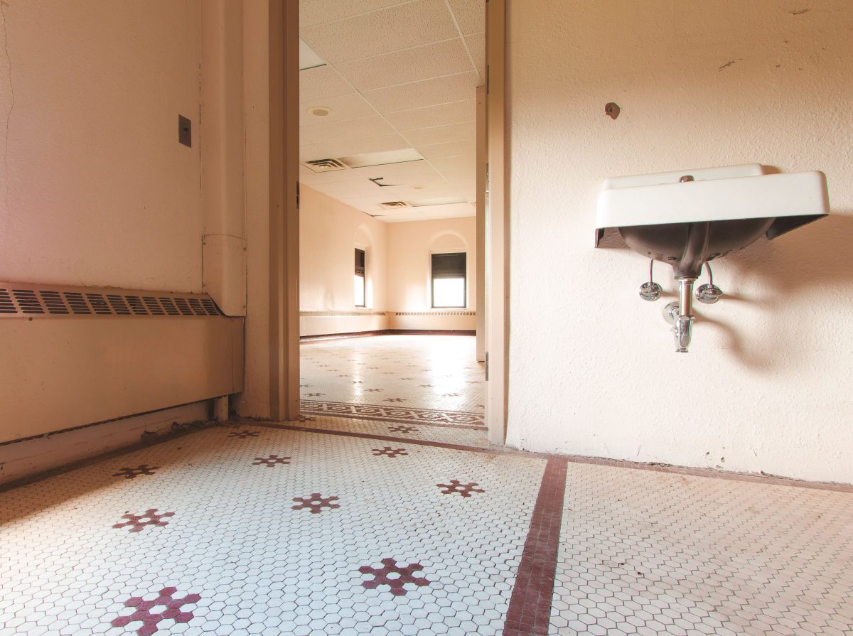 Hexagonal tile floor with wall-mounted sink, Fergus Falls Kirkbride Building