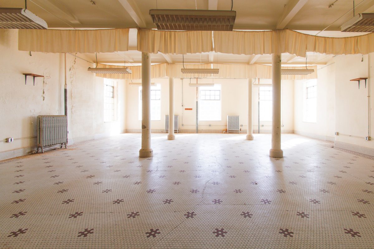 Open dayroom with hexagonal tile floor, Fergus Falls Kirkbride Building