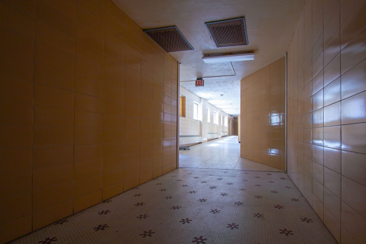 Tiled hallway with exit sign, Fergus Falls Kirkbride Building, Minnesota