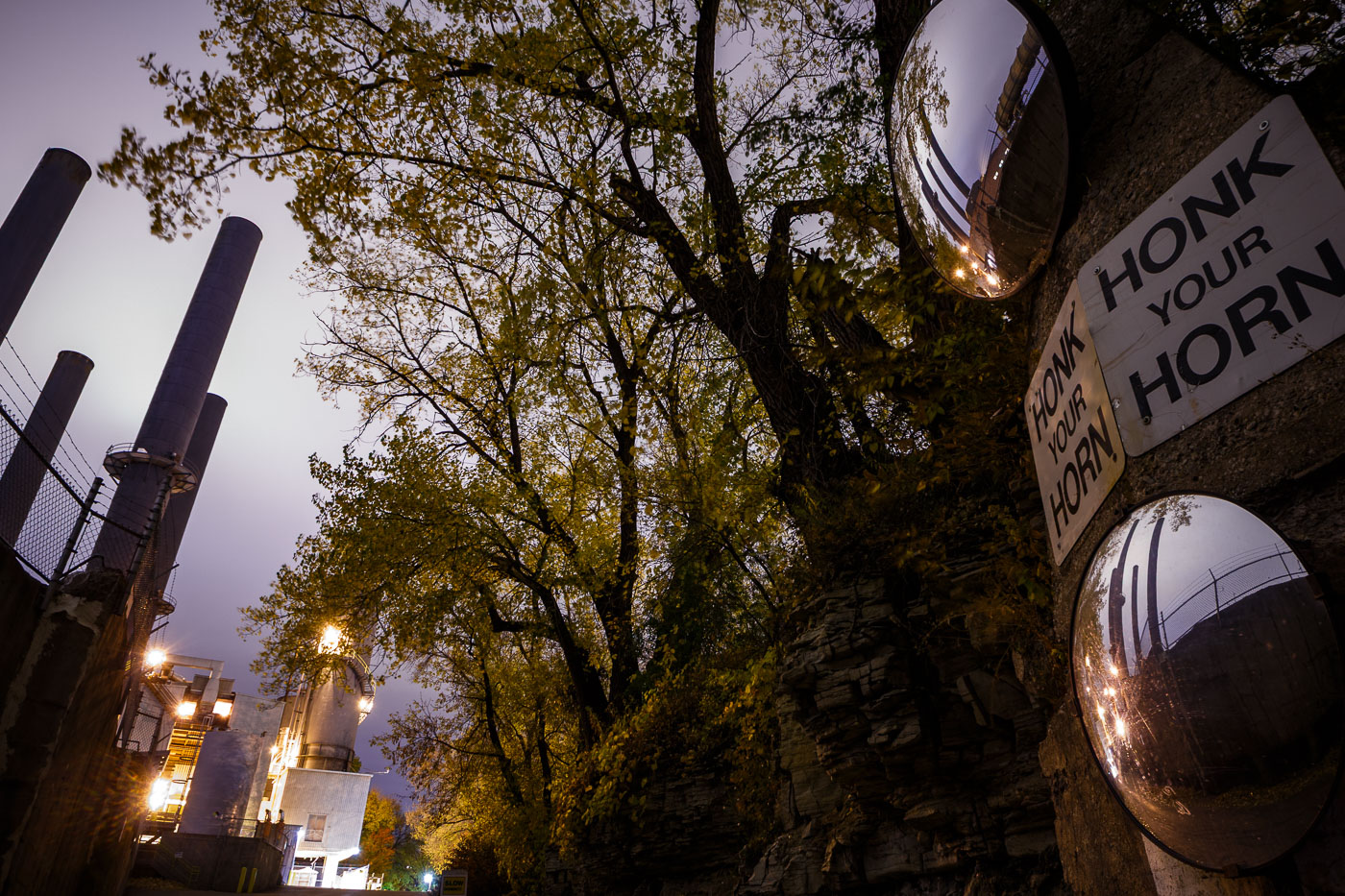The Southeast Steam Plant smokestacks in Minneapolis, a former coal-fired power plant, stand against autumn trees.