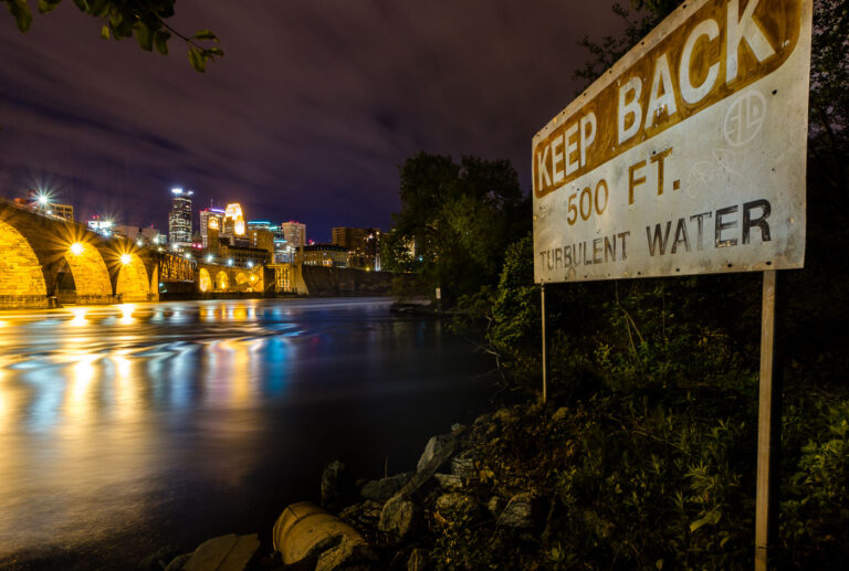 Keep Back Turbulent Water in Minneapolis 3 Sign reading "Keep Back 500 FT Turbulent Water" seen on the Mississippi River in Downtown Minneapolis.