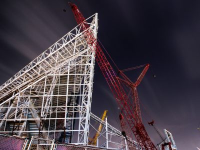 Cranes Over US Bank Stadium's Steel Frame at Night