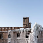 ADM Grain Elevator and Harris Machinery in the front. Harris Machinery covered in ice after a large fire gutted in the inside. Located in Prospect Park, Minneapolis.