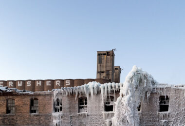 ADM Grain Elevator and Harris Machinery in the front. Harris Machinery covered in ice after a large fire gutted in the inside. Located in Prospect Park, Minneapolis.