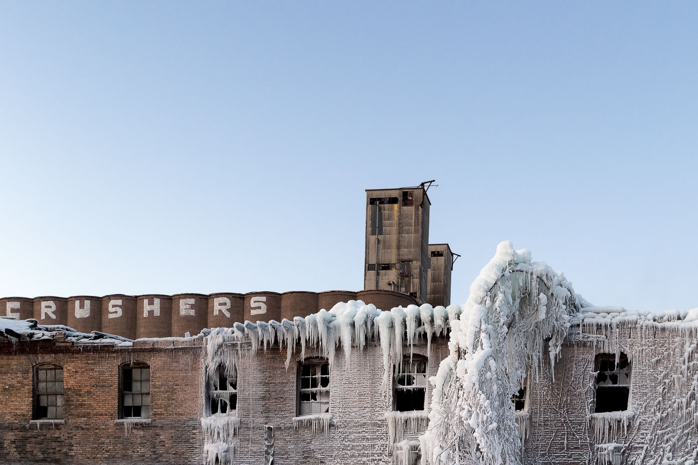 Grain elevator and old building covered in ice after a fire