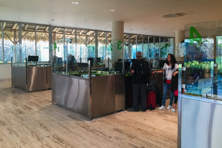 Punta Cana Airport Customs and Immigration Area 1 Passengers at customs and immigration counters in Punta Cana International Airport (PUJ), Dominican Republic. The terminal features modern design with tropical architectural influences.