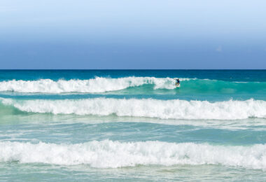 A surfer at Playa Macao in Dominican Republic near Punta Cana.