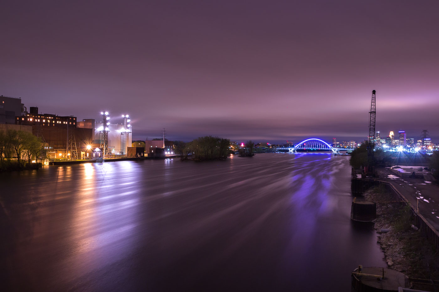 Night photo of power plant and lit up Lowry Bridge