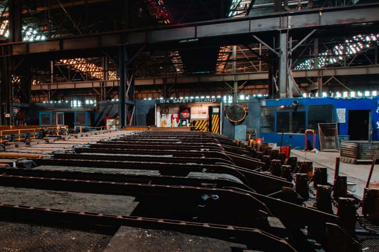 No. 4 Safety Island Inside the ArcelorMittal Steel Mill in East Chicago 1 Industrial steel mill floor at ArcelorMittal East Chicago facility with metal beams, safety equipment, and overhead lighting at night.
