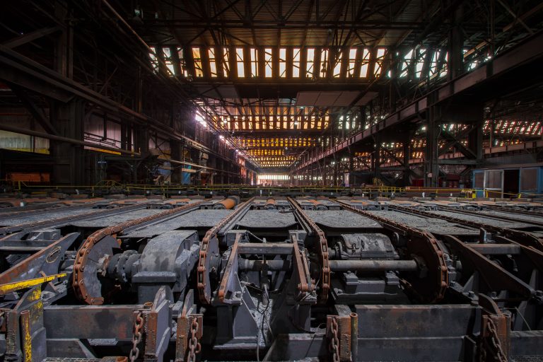 Roller Tables Inside ArcelorMittal's Indiana Harbor Works 4 Abandoned steel mill interior with rusted industrial machinery and overhead lighting at ArcelorMittal in East Chicago.