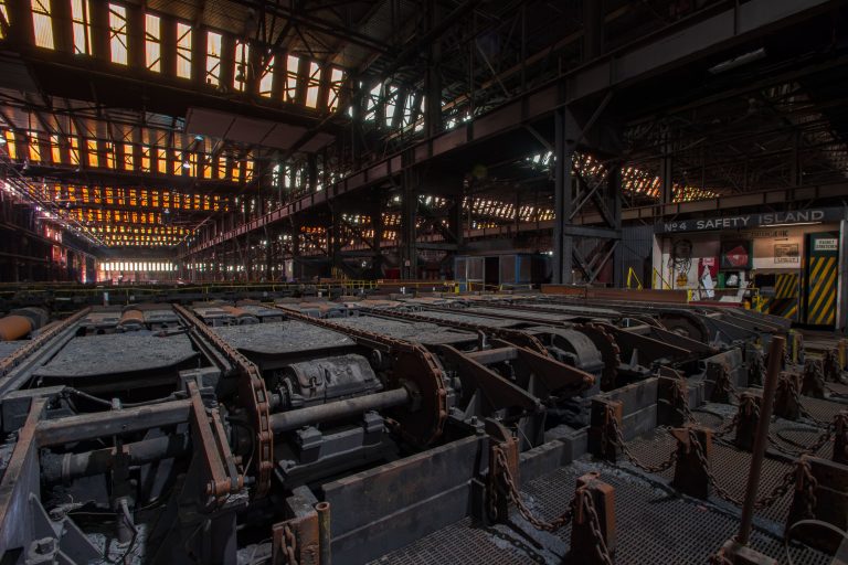 Roller Tables Near No. 4 Safety Island at ArcelorMittal East Chicago 4 Abandoned steel mill foundry floor with rusted machinery, metal framework, and overhead industrial lighting at ArcelorMittal in East Chicago.