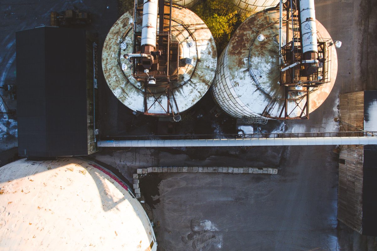 Aerial view of two large circular storage tanks at Upper Harbor Terminal, a former barge facility on the Mississippi River in Minneapolis.