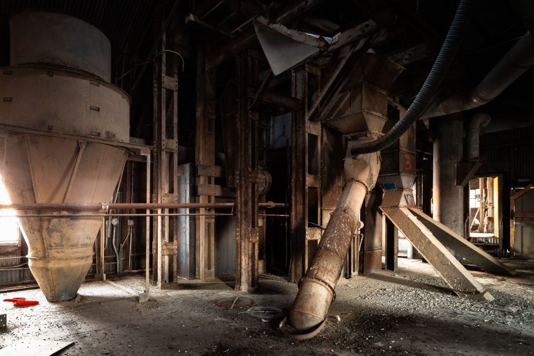 Interior of the abandoned Electric Steel grain elevator in Minneapolis, showing rusted industrial machinery and equipment.