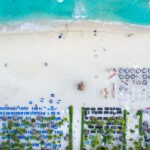 Tables setup on the beach outside Sandos Playacar Beach Resort.
