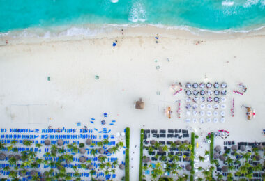 Tables setup on the beach outside Sandos Playacar Beach Resort.