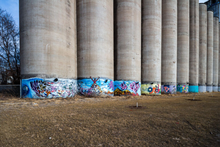 Omaha Grain Elevator Silos with Graffiti Art 2 Concrete grain elevator silos in Omaha, Nebraska, are covered with colorful graffiti art, transforming the industrial structures into a public art display.