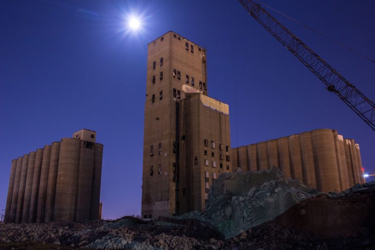 Dinkytown Grain Elevator Complex Under Demolition, Minneapolis 1 Concrete grain elevator complex with silos and headhouse during demolition in Dinkytown, Minneapolis.