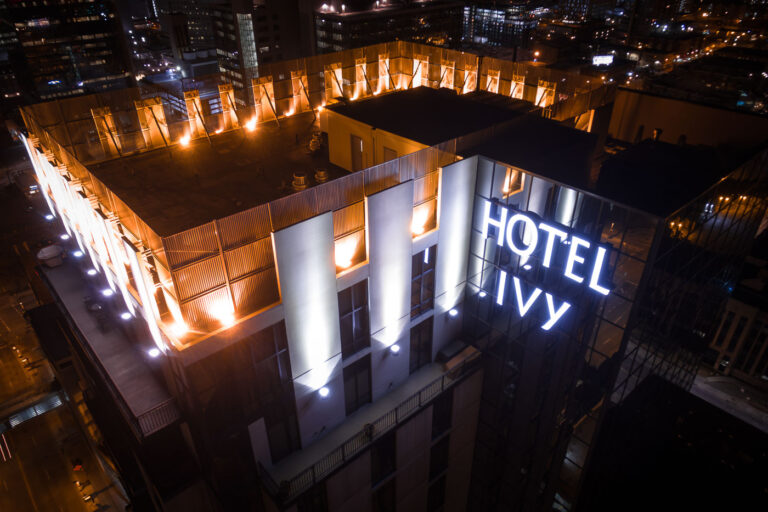 Hotel Ivy Rooftop and Downtown Minneapolis at Night 1 Hotel Ivy, a luxury hotel in downtown Minneapolis, is illuminated at night, showcasing its modern architecture and rooftop area with views of the city's central business district.