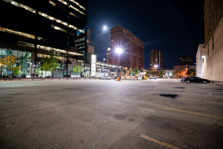Marquette Avenue Parking Lot at 9th, Minneapolis 4 Marquette Avenue in downtown Minneapolis at night, with office towers and an open parking lot.