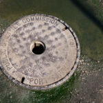 A 1906 manhole cover from the former Port Arthur Public Utilities Commission, now part of Thunder Bay’s unified public works system. Before amalgamating with Fort William in 1970, Port Arthur operated its own water, sewer, and electrical services, reflecting the industrial ambitions of this Lake Superior port. Cast in iron more than a century ago, the cover remains a tangible remnant of early municipal engineering in northwestern Ontario.