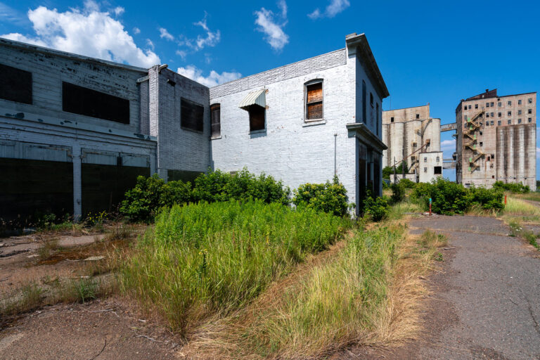 Abandoned Buildings at Saskatchewan Pool B, Thunder Bay 3 The remains of the Saskatchewan Pool B complex in Thunder Bay, Ontario, stand as a testament to the city’s industrial and maritime heritage. Once part of one of the largest grain handling networks on the Great Lakes, these structures were built in the early 20th century to serve the growing wheat trade flowing from the Canadian Prairies to Atlantic markets. Operations here slowed by the 1980s as newer, more efficient elevators replaced them. Today, the site lies silent along the waterfront, its silos and offices weathered by decades of Lake Superior winds.