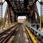 This steel swing bridge in Thunder Bay, Ontario, carries the Canadian Pacific Railway line across the Kaministiquia River near the city’s grain terminals. Built in the early 20th century, the structure allowed both rail and maritime traffic to pass through the busy industrial waterfront—pivoting open for ships bound to and from Lake Superior. The bridge remains an important relic of Thunder Bay’s era as one of Canada’s foremost grain-shipping hubs, linking prairie rail lines to Great Lakes freighters and global export routes.