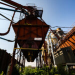 Conveyor Systems at the Former Great West Lumber Sawmill, Thunde 3 The rusting conveyor systems and storage bins of the former Great West Lumber Sawmill stand as remnants of Thunder Bay’s once-thriving forest industry. Established near the Lake Superior waterfront in the early 20th century, the mill was part of a vast network that processed and shipped lumber across North America. Its maze of steel ducts and conveyors once carried sawdust, chips, and milled timber, feeding the region’s economic boom. Today, the overgrown machinery reflects a post-industrial landscape—silent evidence of a city that helped fuel Canada’s forestry trade for generations.