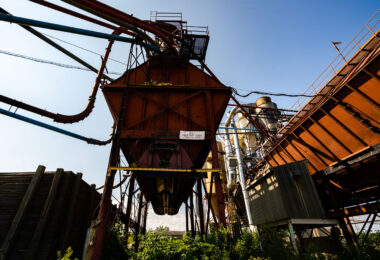 The rusting conveyor systems and storage bins of the former Great West Lumber Sawmill stand as remnants of Thunder Bay’s once-thriving forest industry. Established near the Lake Superior waterfront in the early 20th century, the mill was part of a vast network that processed and shipped lumber across North America. Its maze of steel ducts and conveyors once carried sawdust, chips, and milled timber, feeding the region’s economic boom. Today, the overgrown machinery reflects a post-industrial landscape—silent evidence of a city that helped fuel Canada’s forestry trade for generations.