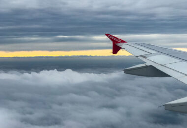 Looking out the window at the wing of an airplane with Air Berlin logo painted on it.