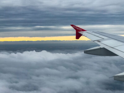Air Berlin Wing Above Clouds at Sunset